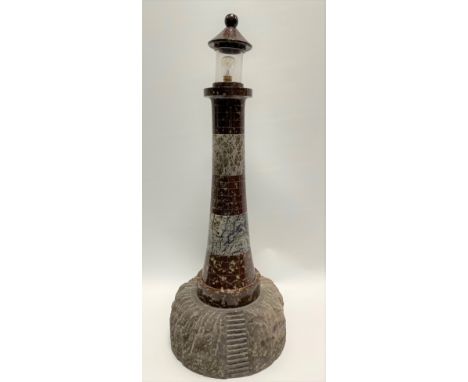 A large red and grey Cornish serpentine sectional lighthouse table lamp, height 64.5cm