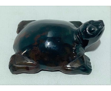 A green and russet flecked jade carved tortoise, width 4.5cm.