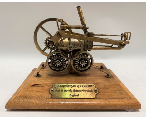 Modern brass scale model of Richard Trevithick's steam locomotive with brass plaque to the wooden base with inscription 'The 