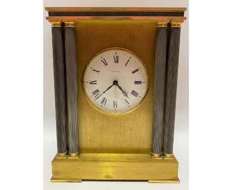A brass cased mantle clock by Looping, the 4 inch signed enamel dial with roman numerals, the brushed brass case with four fl