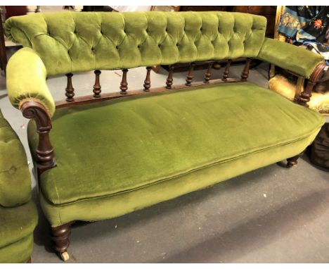 Victorian button-back green velvet upholstered settee, the button-back rail over turned supports, the arms with scroll carved