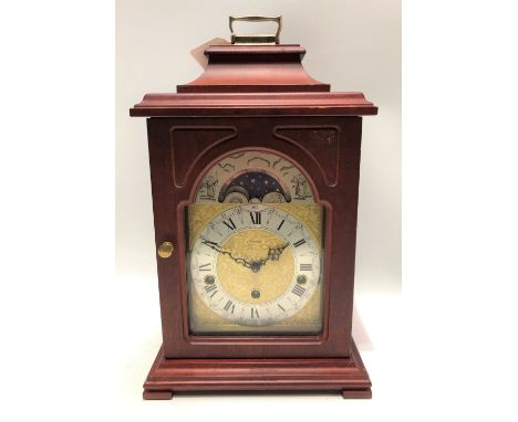 A German three-train bracket style mantle clock by Hermle, the 5in dial with moon phase aperture, the movement striking on ei