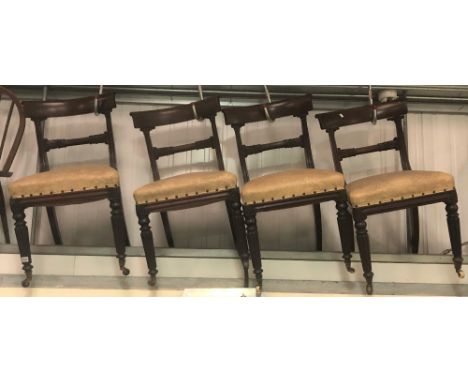 Set of four William IV mahogany dining chairs with stiff leaf carved mid rail over an upholstered stuff-over seat and raised 