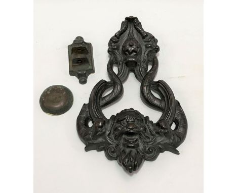 A large 19th Century door knocker cast with a grotesque bearded mask flanked by two coiled dolphins, height 23cm x width 16cm
