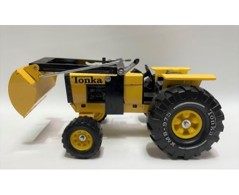 Four Tonka tin plate toy vehicles, including a trencher no. 2534, with box, bulldozer no. 2300, boxed tractor with loader and