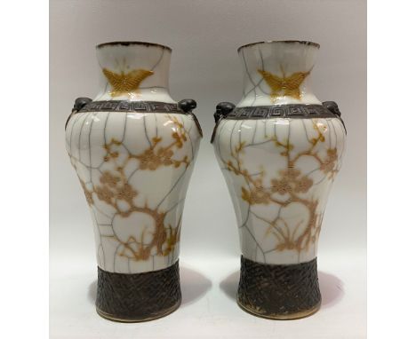 A pair of 20th Century Chinese crackle glazed vases painted in yellow enamel with a blossoming tree and butterfly, height 22c