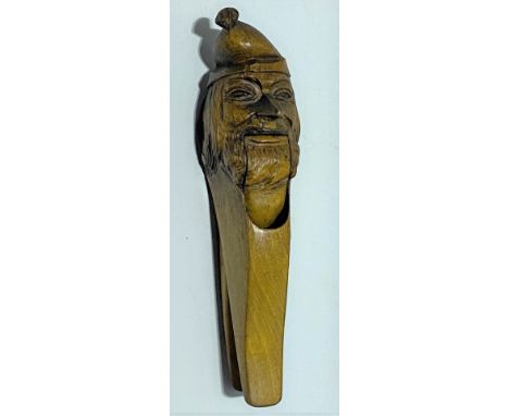 Carved wood nutcracker in the form of a bearded gentleman with nightcap, width 18cm.