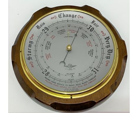 An aneroid barometer within mahogany case, with 8 inch silvered dial, signed 'Shortland Smiths'.