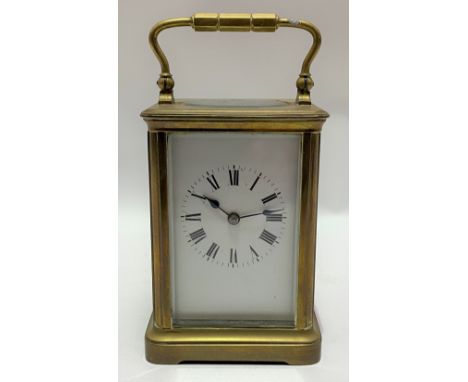 French brass cased carriage clock, the 2.5in white enamel dial with black Roman Numerals, the movement striking on a gong, wi