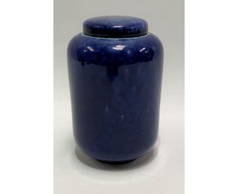 A Ruskin Pottery blue soufflé glaze cylindrical jar and cover, impressed marks to the base and No.1906, height 15cm.