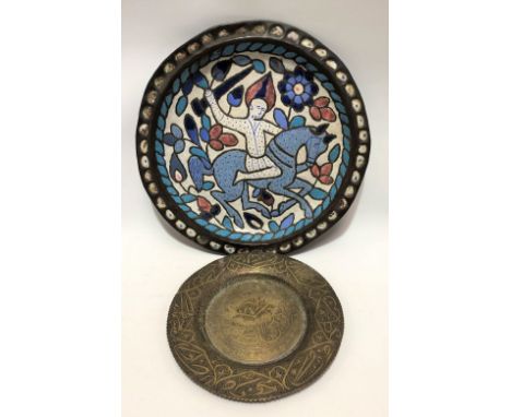 A Persian copper and enamel circular dish decorated with a warrior on horseback amongst foliate scrolls, diameter 35.5cm; tog
