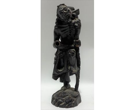 Chinese carved root figure of a sage with walking stick upon a turtle, height 23.5cm (AF)