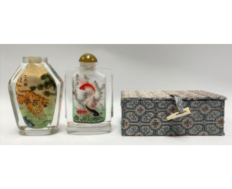 Two 20th Century Chinese reverse painted glass snuff bottled and stoppers, one within silk fitted box