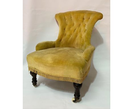 Victorian button-back nursing chair with turned and fluted fore legs with ceramic castors