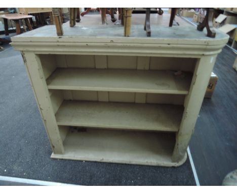 An early 20th century cream painted corner book shelf