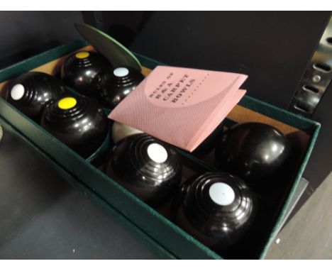 A boxed selection of carpet bowls