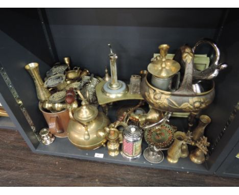 A shelf of decorative metalware including brass trivet, copper large mug etc