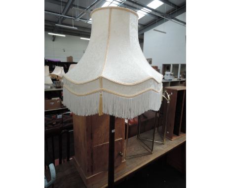 A traditional oak column standard lamp