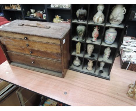 A ceramic display shelf and collectors drawers