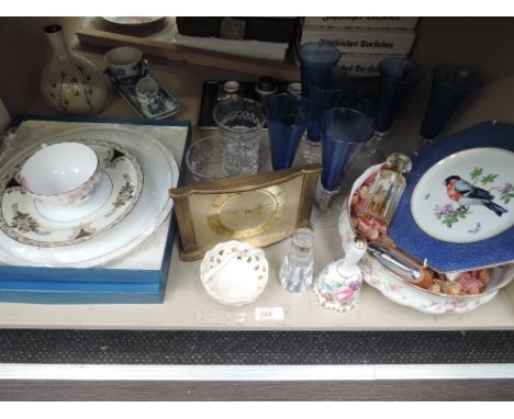 A miscellaneous shelf of ceramics, clock and glass