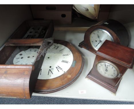 A shelf of mantle clocks and clock parts