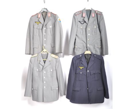 Uniforms - A group of four German, Nazi, Third Reich costume uniform jackets having badges with epaulettes and the relevant i