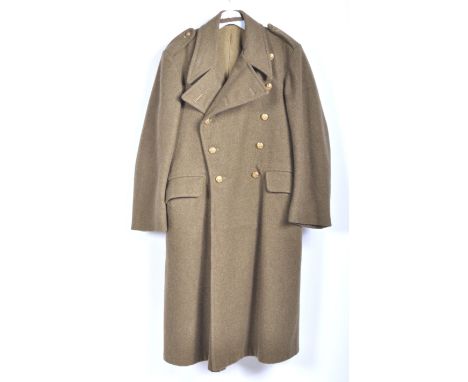 Uniforms - A genuine 1952 British Army military woolen over greatcoat having epaulettes, regimental buttons and original make