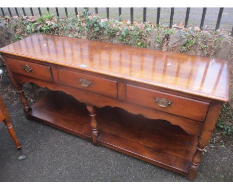 A reproduction oak Titchmarsh &amp; Goodwin dresser base with three drawers and shelf below 76cm h x 168 cm w 