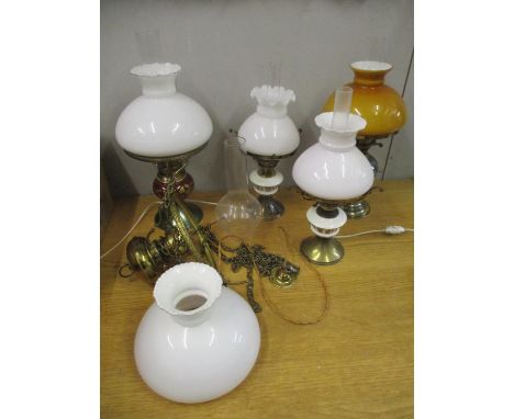 A Duplex oil lamp (converted to electricity) with glass shade and smoke funnel, three other table lamps with porcelain reserv