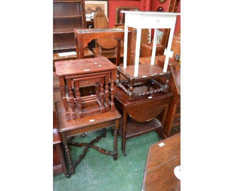 An oak nest of three tables; an oak occasional table with barley twist supports; an oak footstool; an oak dropleaf tea trolle