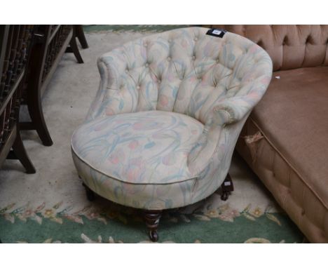 A Victorian button back nursing chair, stuffed-over seat, turned forelegs, ceramic casters