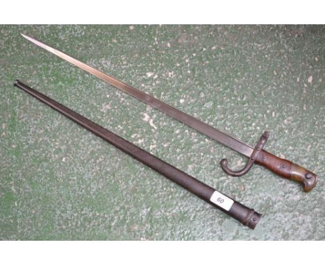 A 19th century French gras bayonet, T shaped blade, etched back edge, marked St Etienne 1878, serial No 43596, wooden and bra