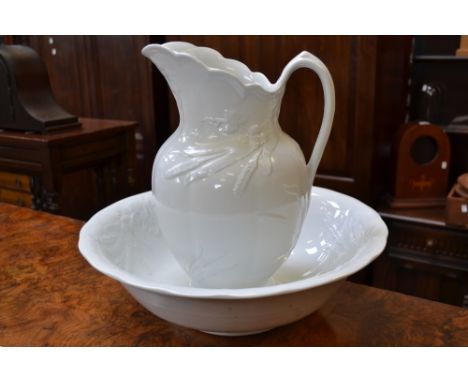 A J&G Meakin wash jug and bowl, glazed in white, moulded with wheat sheaves and trailing vine