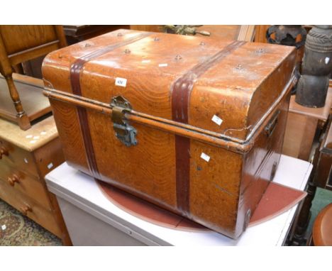 A dome top tin trunk