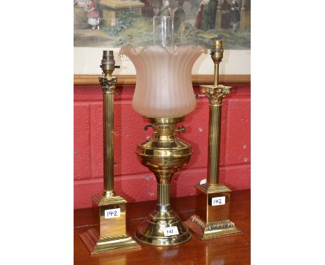 A 20th century brass Corinthian column table lamp, stepped square base; another, similar; a brass oil lamp converted to elect