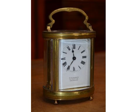 A brass carriage clock, W.S.Cooper, The Promenade, Cheltenham, ovoid cylindrical shape, Roman numerals