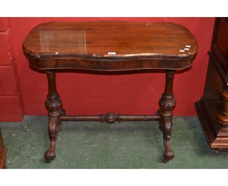 A Victorian  rosewood card table, serpentine fold over top enclosing red baize playing surface, turned fluted and lobed suppo