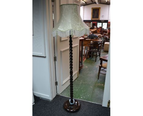 An oak barley twist standard lamp, circular socle, bun feet, c.1940's