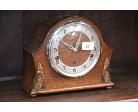 A 1920's oak Westminster chime mantel clock, Arabic numerals, eight day, key and pedulum 