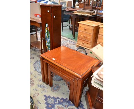 A mahogany nest of three tables, crossbanded top; a mahogany TV stand; a mahogany CD tower with glazed door (3)