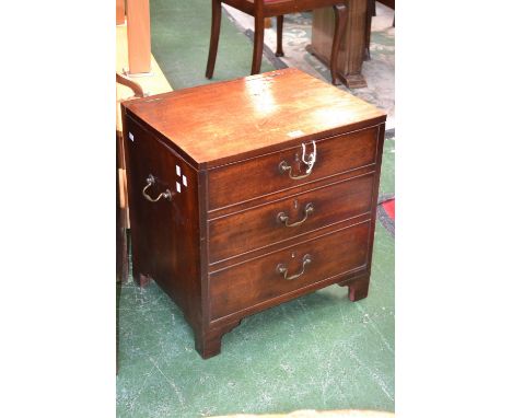 A George III mahogany commode, converted into a storage chest, hinged cover above three drawers, brass swan neck handles, oge