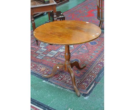 A George III oak circular tilt top table, canon barrel column, tripod base pad feet, c1800