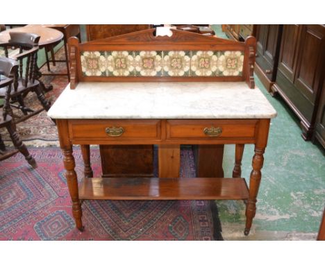 A Victorian mahogany tile back marble top washstand, two short drawers to frieze, undertier, turned supports, ceramic casters