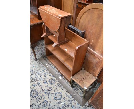 An oak floor standing bookcase; an oak dropleaf occasional table; a rope seated stool; a bamboo firescreen face; a brass Art 