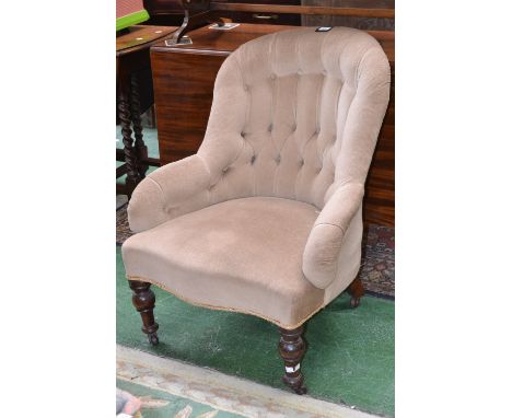A Victorian button back nursing chair, serpentine fronted seat, turned forelegs, ceramic casters