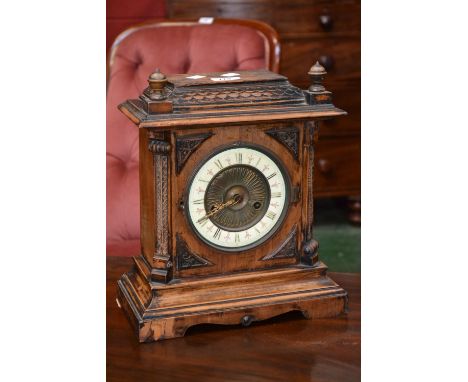 An Oak mantel clock, enamelled chapter ring 