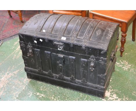 A vintage dome topped trunk with metalwork decoration
