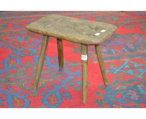 A rustic stool, rectangular top