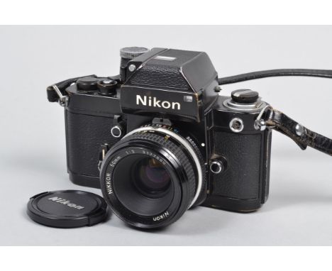 A Nikon F2 Photomic SLR Camera, black, serial no 7160853, body F, paint losses to baseplate, brassing to edges, DP1 prism F, 