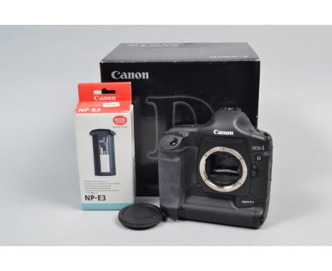 A Canon EOS-1D Mark II N DSLR Body, serial no 410915, body G, slight whitening to handgrip, faint marks to rear screen, with 